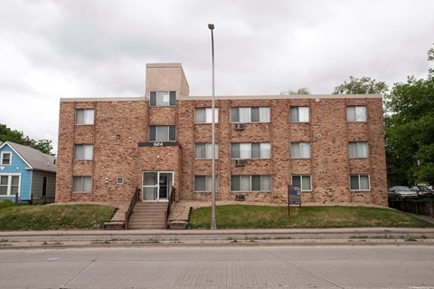 a large brick building with a flagpole in front of it